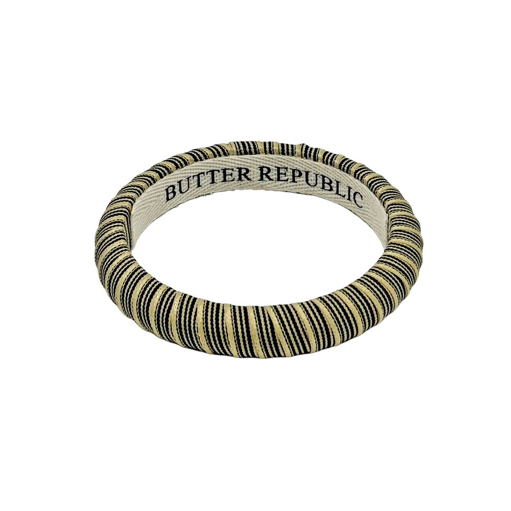 black and cream pinstripe Butter Republic bracelet with logo brand label on the bracelet interior