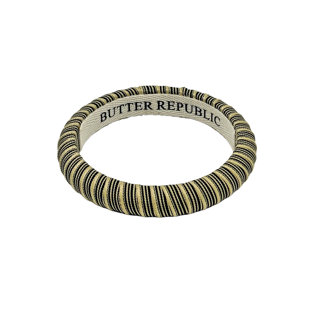 black and cream pinstripe Butter Republic bracelet with logo brand label on the bracelet interior