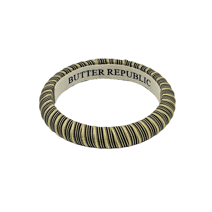 black and cream pinstripe Butter Republic bracelet with logo brand label on the bracelet interior