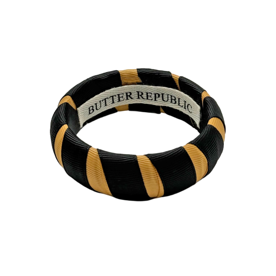 black and gold Butter Republic bracelet with logo brand label on the bracelet interior