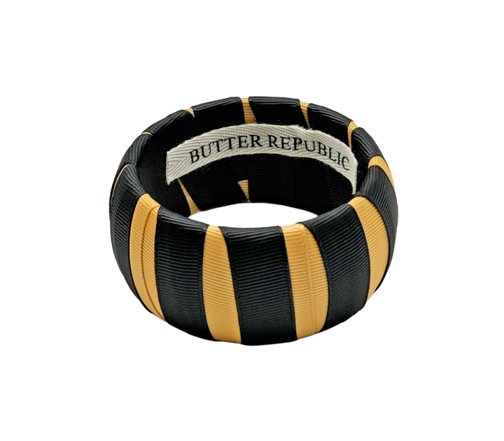black and gold Butter Republic bracelet with logo brand label on the bracelet interior