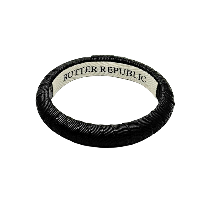 narrow black Butter Republic bracelet with brand label on the interior
