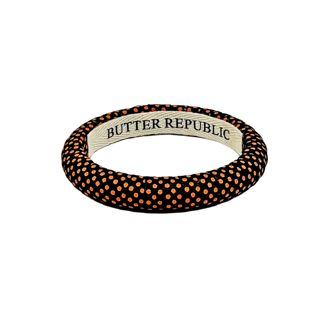 Black Butter Republic narrow bangle bracelet with orange Swiss polka dots