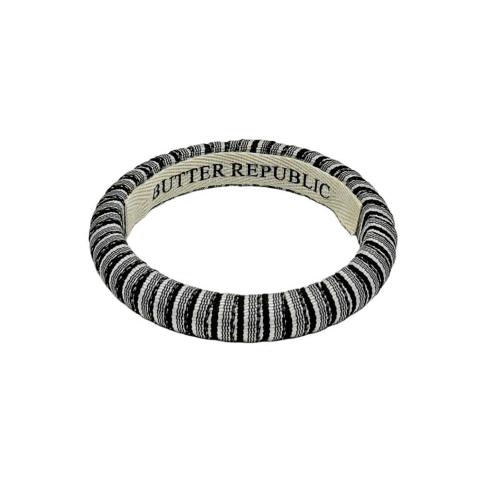 black and white pinstripe Butter Republic bracelet with logo brand label on the interior of the bracelet