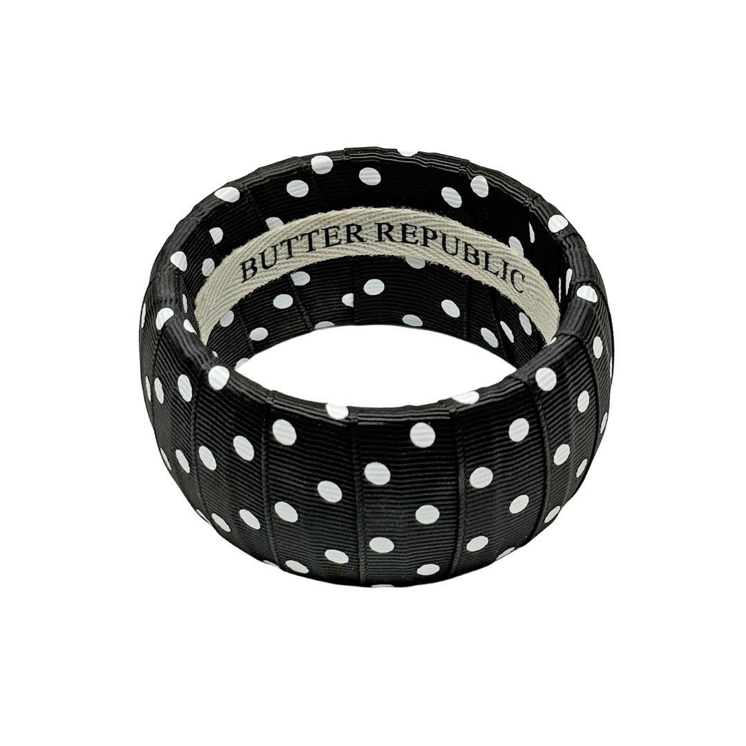 Black and white polka dot bracelet with Butter Republic brand label on the interior