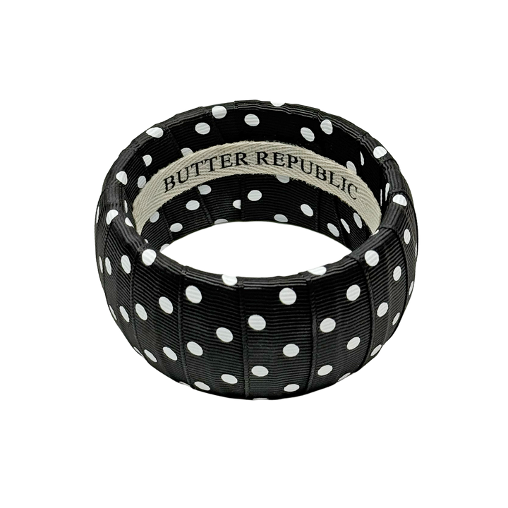Black and white polka dot bracelet with Butter Republic brand label on the interior