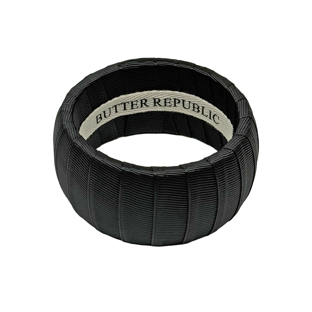 Black bracelet with Butter Republic brand label on the interior