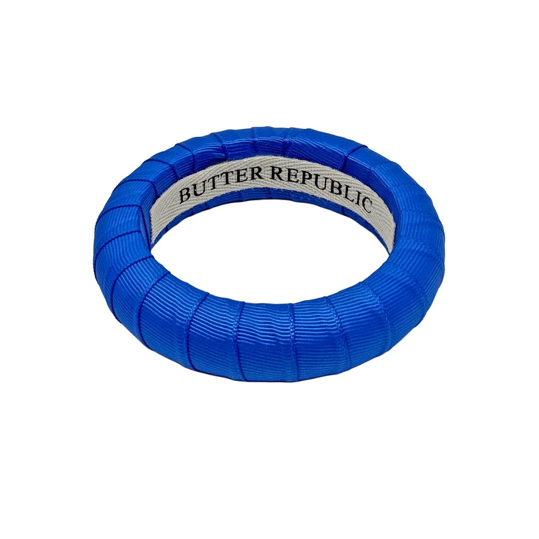 Blue bracelet with Butter Republic'  branding label on the interior