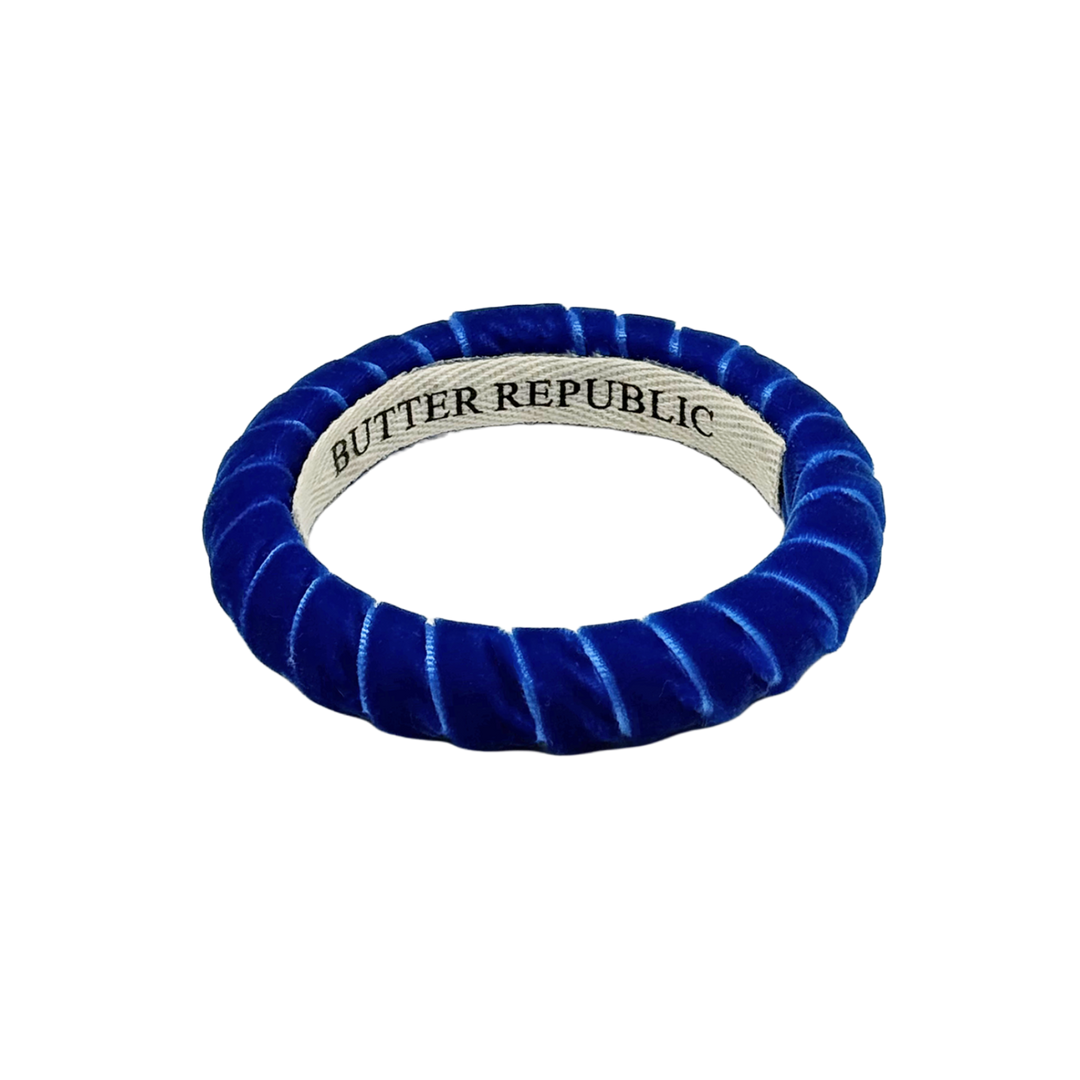 blue velvet Butter Republic bracelet with logo brand label on the interior of the bracelet