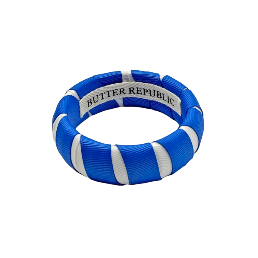 blue and white Butter Republic bracelet with logo brand label on the interior of the bracelet