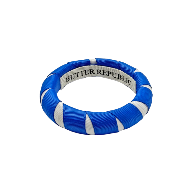 blue and white Butter Republic bracelet with logo brand label on the interior of the bracelet