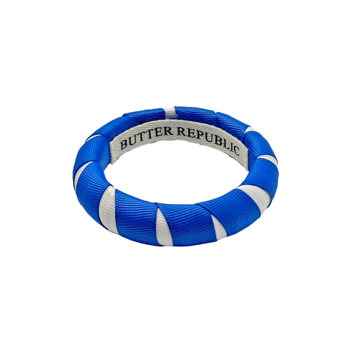 blue and white Butter Republic bracelet with logo brand label on the interior of the bracelet