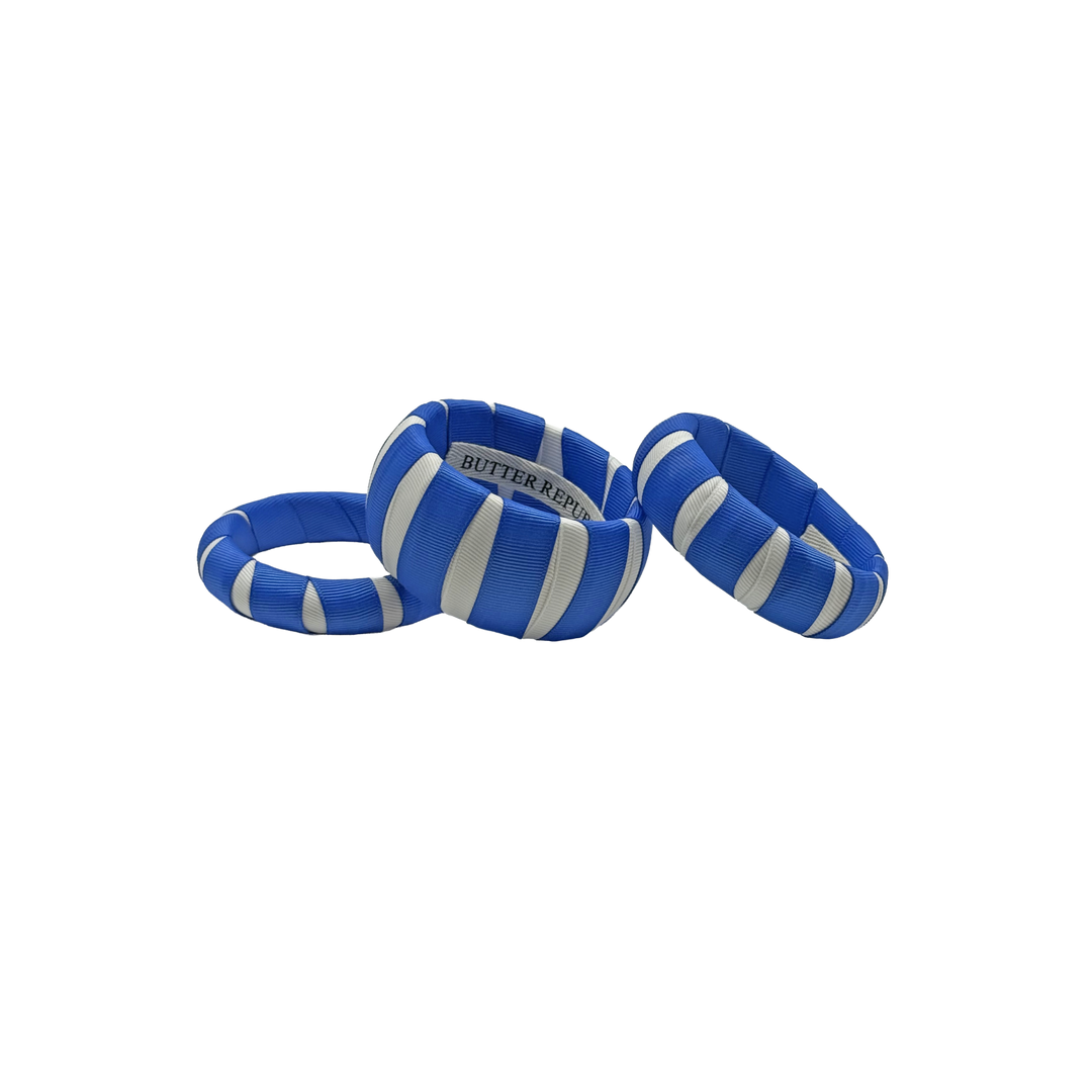 three multi-sized blue and white Butter Republic classic bracelets with logo brand label on the interior of the bracelet