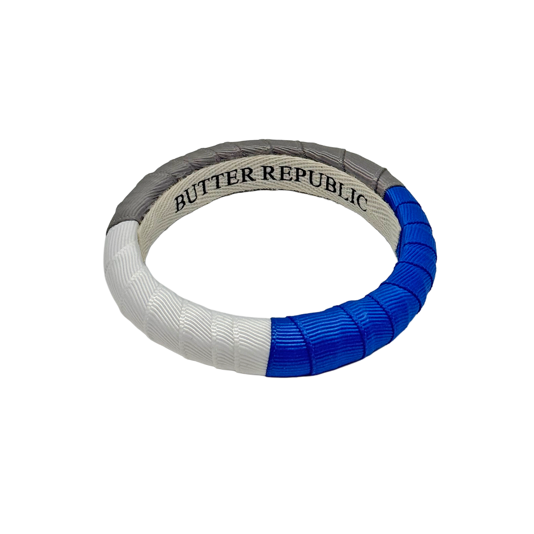 Butter Republic bangle bracelet with blue and white design, and brand label on the interior