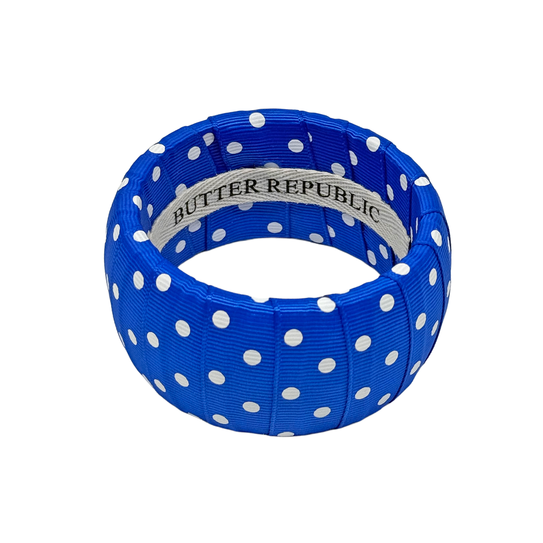 Blue and white polka bracelet with Butter Republic brand label on the interior