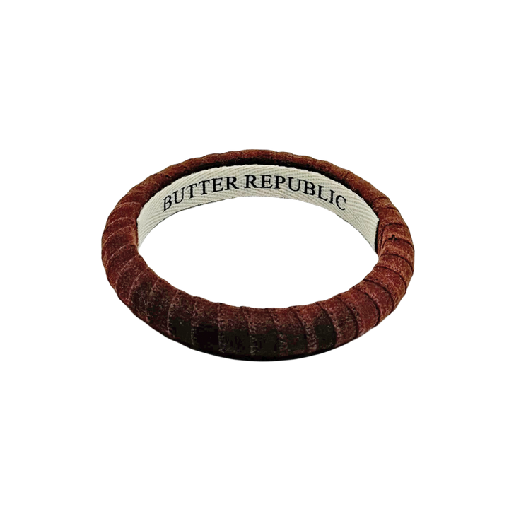 brown suede Butter Republic bracelet with logo brand label on the interior of the bracelet