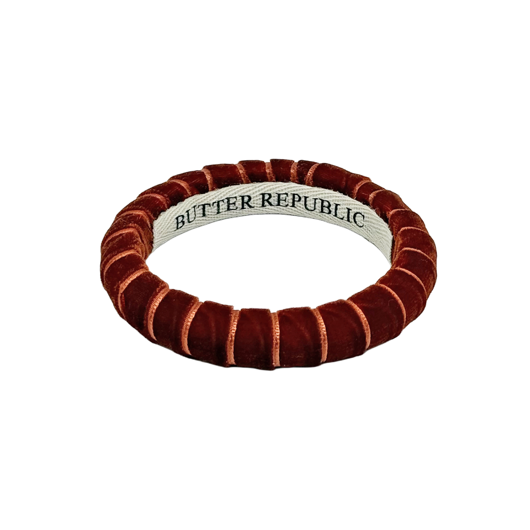 A rust/brown-colored Butter Republic velvet bracelet