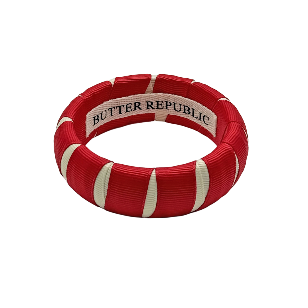 crimson and cream Butter Republic bracelet with logo brand label on the interior of the bracelet