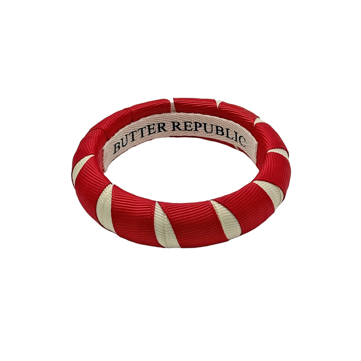 crimson and cream Butter Republic bracelet with logo brand label on the interior of the bracelet