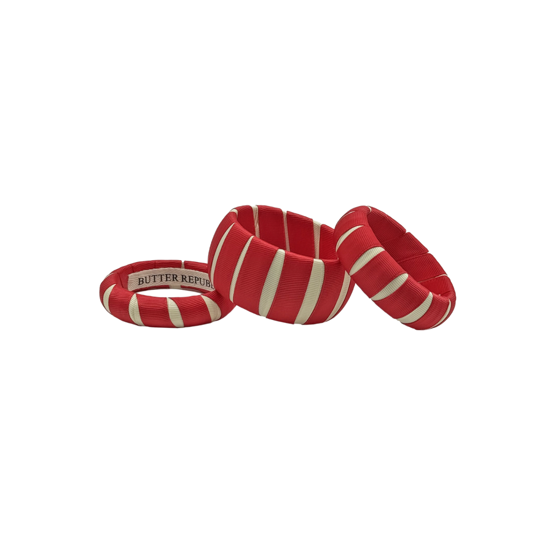 3 multi-width crimson and cream Butter Republic bracelets with logo brand label on the interior of the bracelet