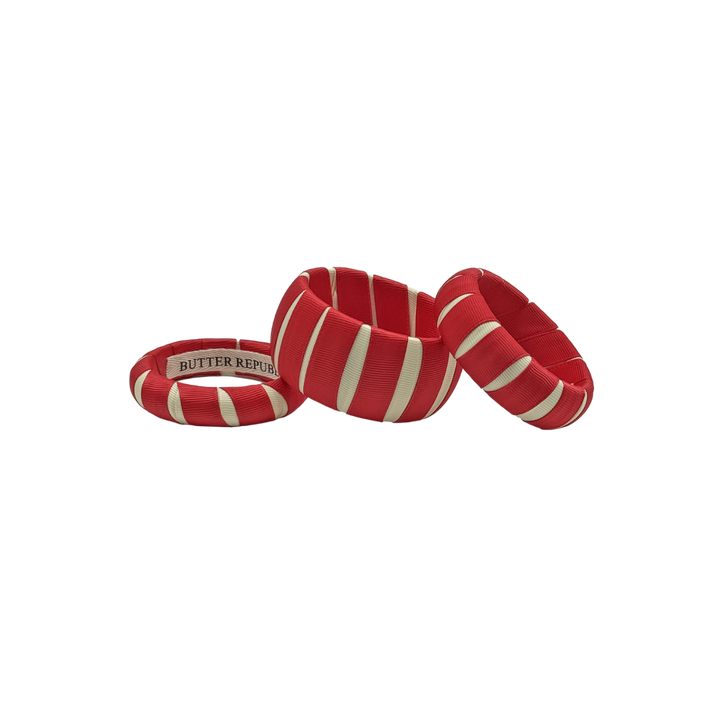 3 multi-width crimson and cream Butter Republic bracelets with logo brand label on the interior of the bracelet