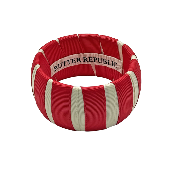 crimson and cream Butter Republic bracelet with logo brand label on the interior of the bracelet