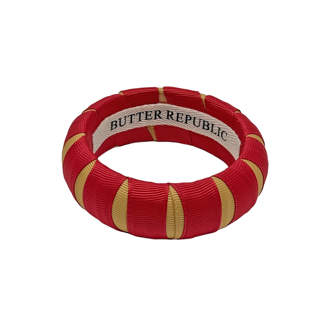 crimson and gold Butter Republic bracelet with logo brand label on the interior of the bracelet