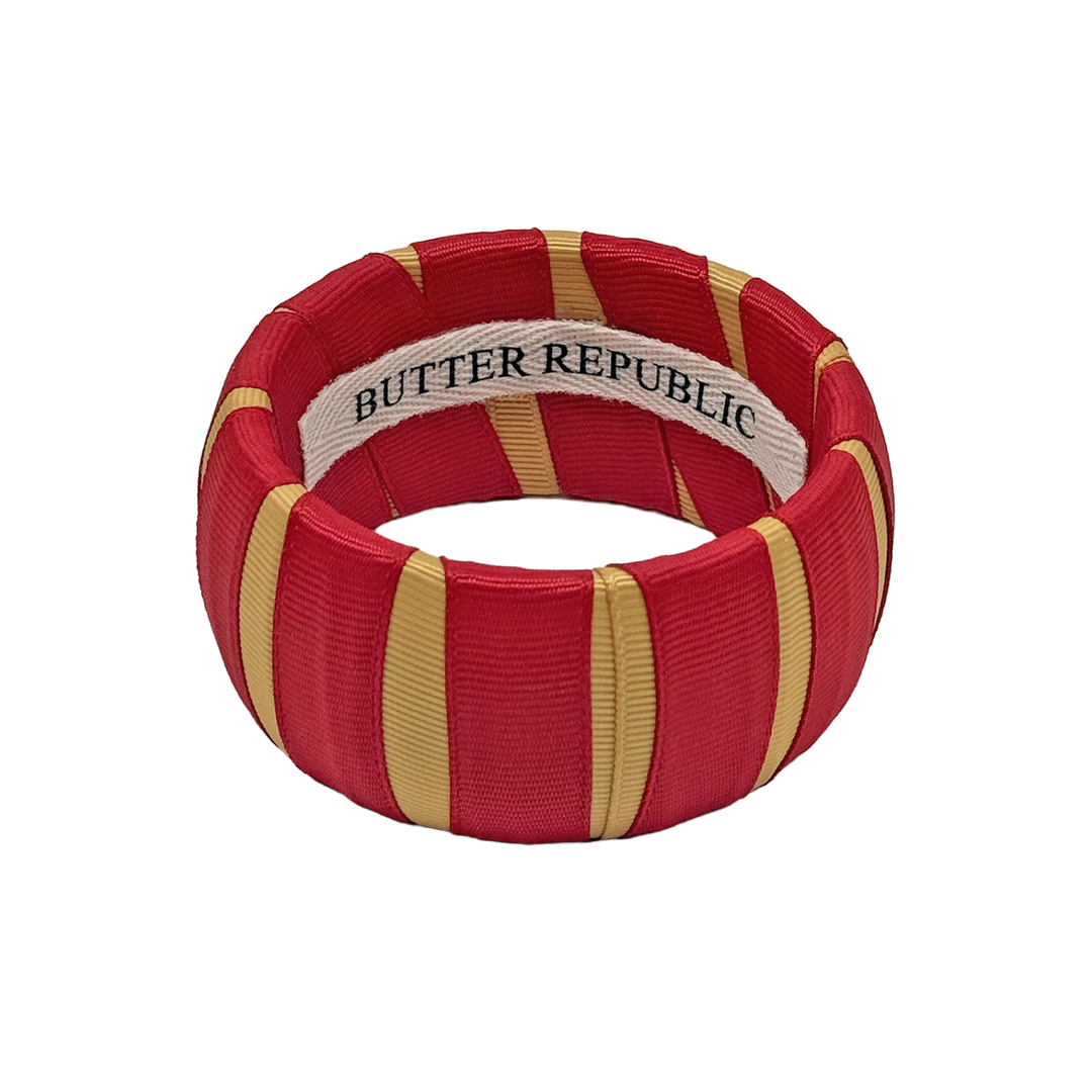 crimson and gold Butter Republic bracelet with logo brand label on the interior of the bracelet