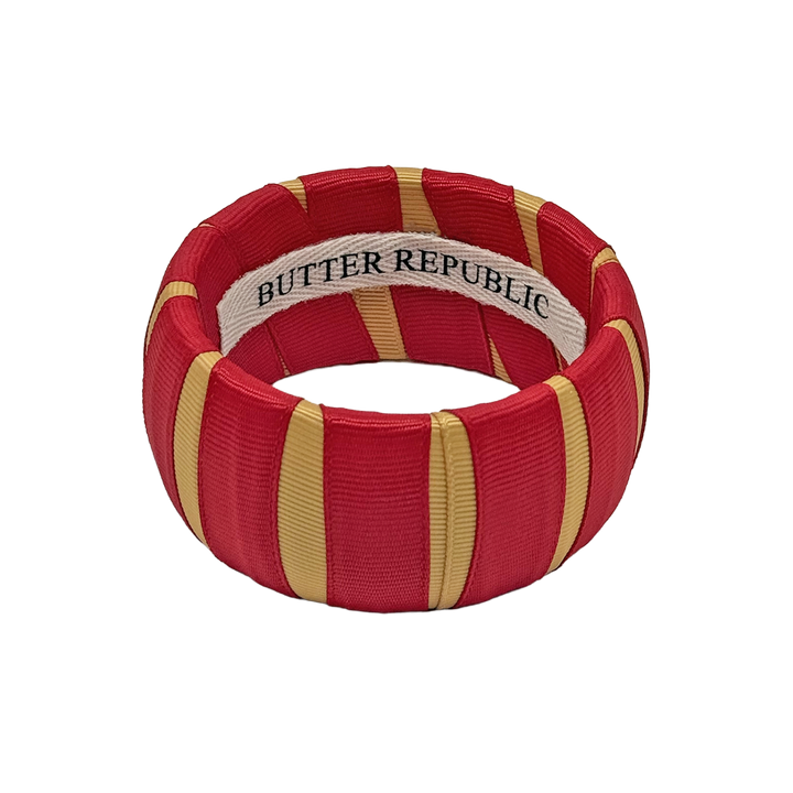 crimson and gold Butter Republic bracelet with logo brand label on the interior of the bracelet