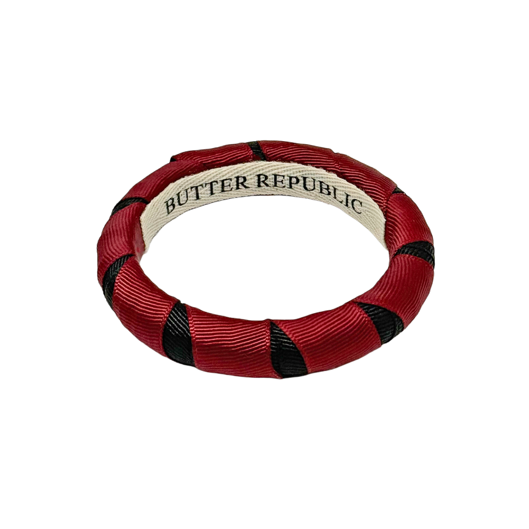Garnet and black Butter Republic bangle bracelet with brand label on the interior