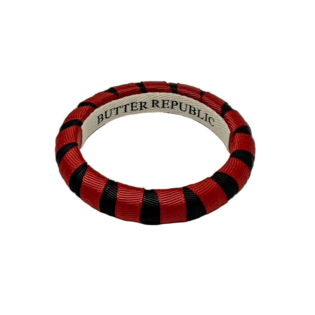 Garnet and black Butter Republic bracelet with brand label on the interior