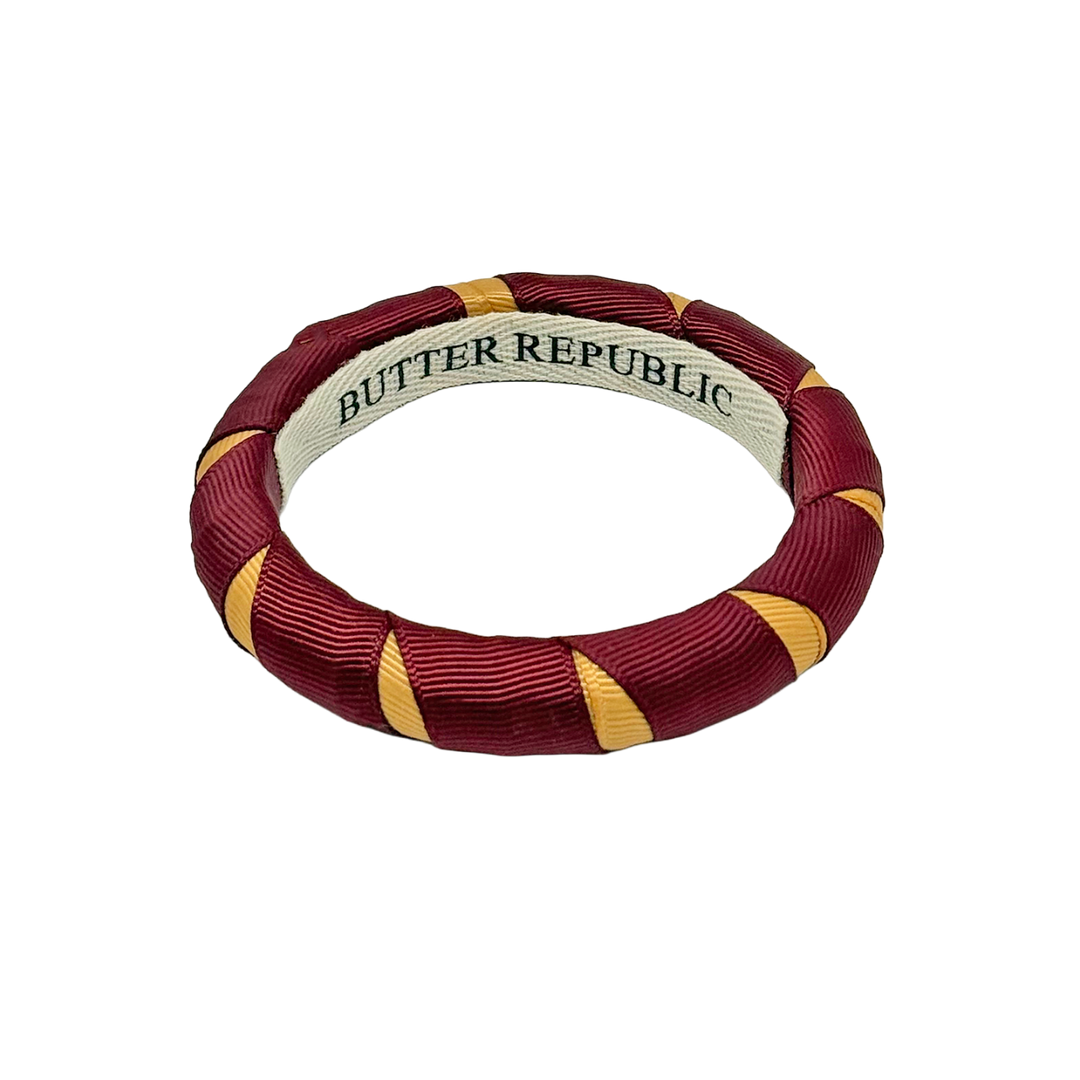 Garnet and gold Butter Republic bangle bracelet with brand label on the interior
