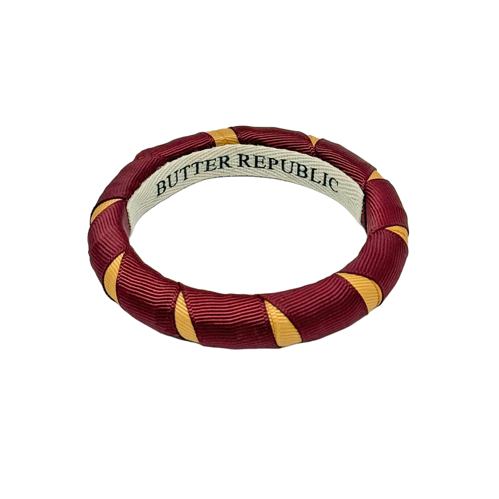 Garnet and gold Butter Republic bangle bracelet with brand label on the interior