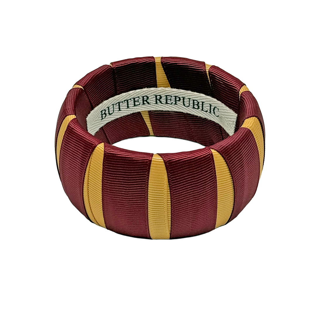 Garnet and gold Butter Republic bracelet with brand label on the interior