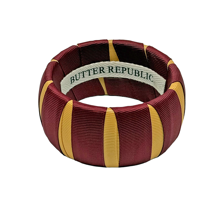Garnet and gold Butter Republic bracelet with brand label on the interior