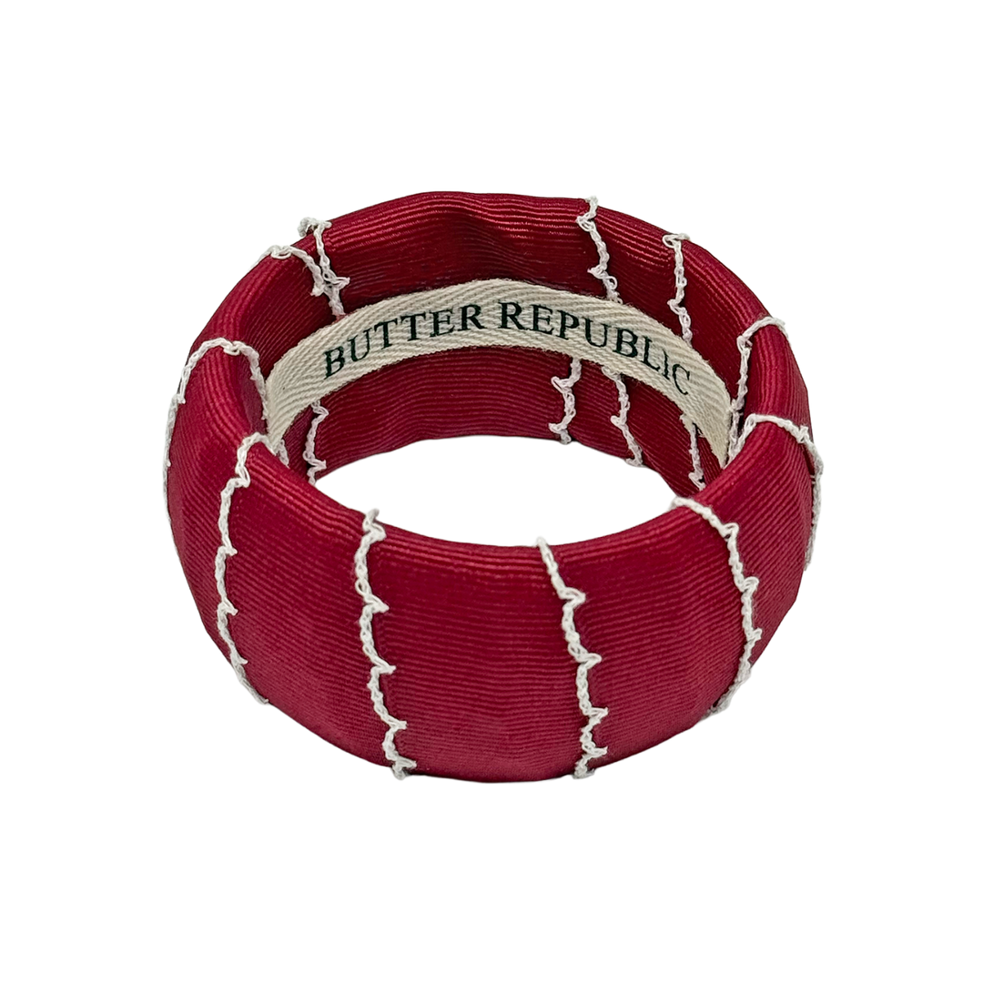 Garnet bracelet with white trim; Butter Republic' brand label on the interior