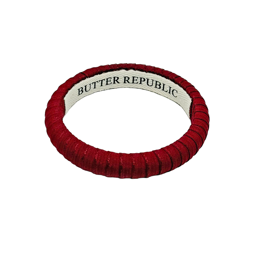 Garnet Butter Republic bangle bracelet with brand name label on the interior 