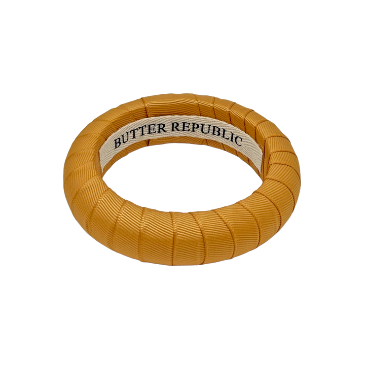 Gold bracelet with Butter Republic label on the interior