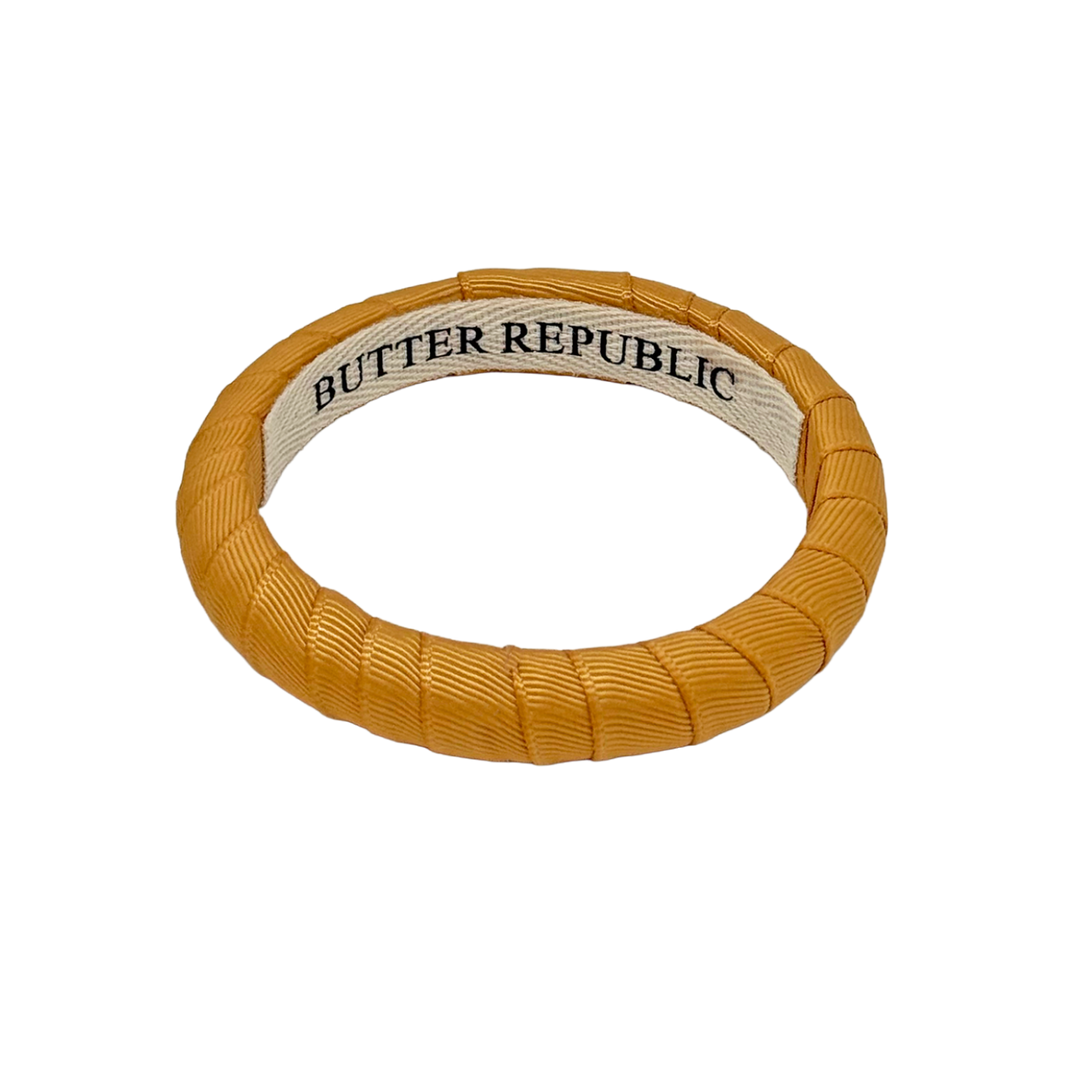 Gold bracelet with Butter Republic brand label on the interior