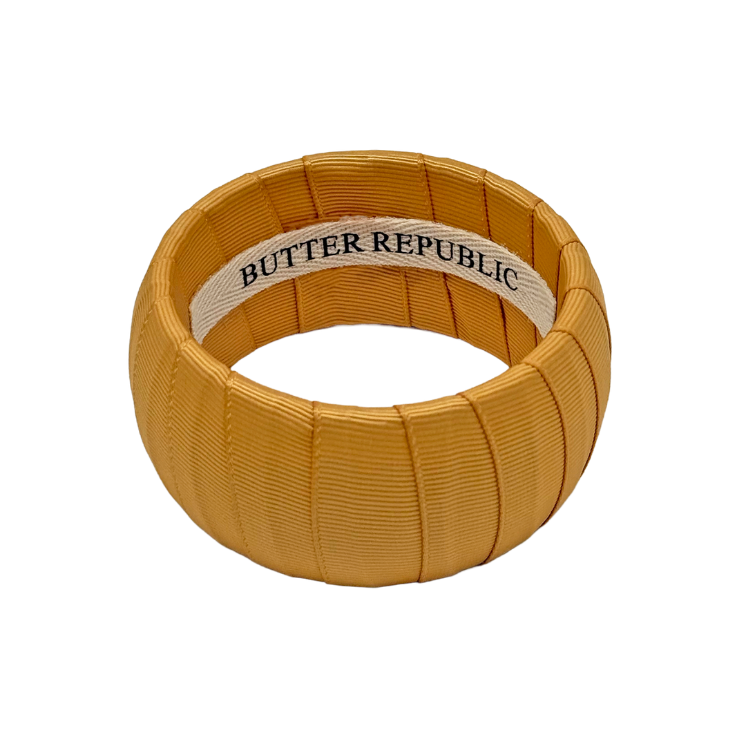 Gold bracelet with Butter Republic brand label on the interior