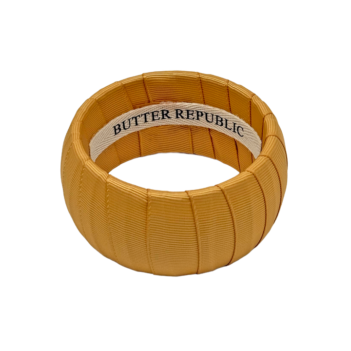 Gold bracelet with Butter Republic brand label on the interior