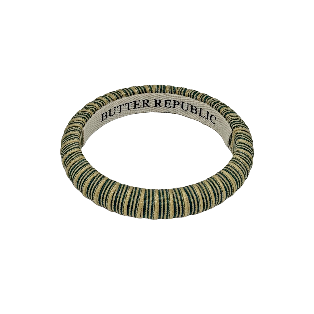 Green and cream striped Butter Republic bangle bracelet with brand label on the interior