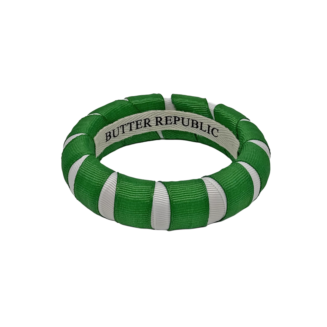 A green and white Butter Republic bracelet