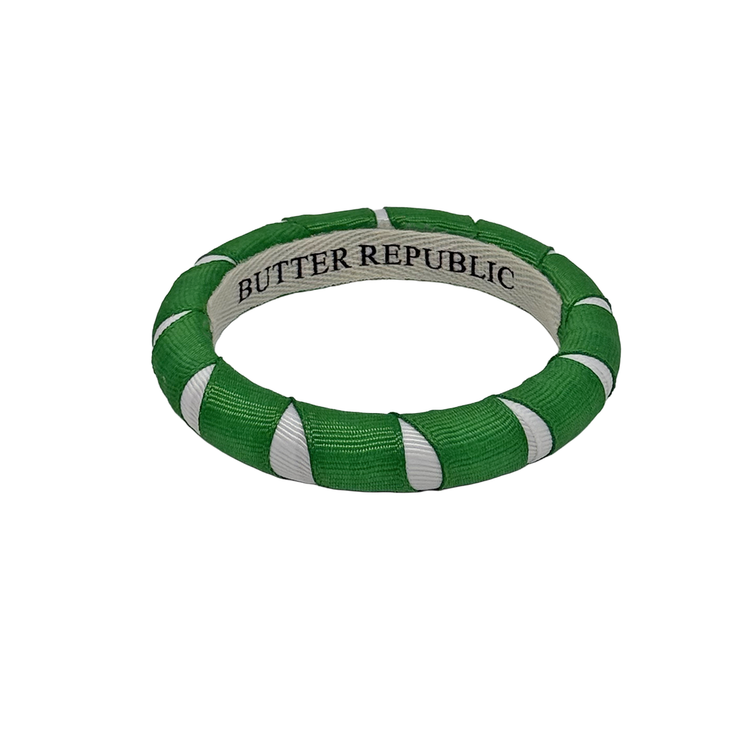 A green and white Butter Republic bracelet