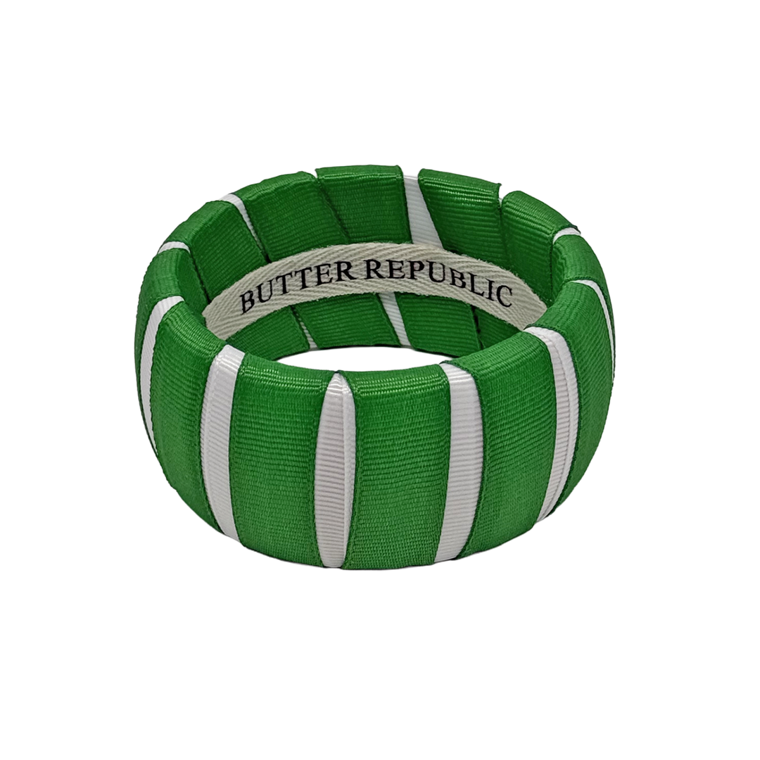 A green and white wide Butter Republic bracelet