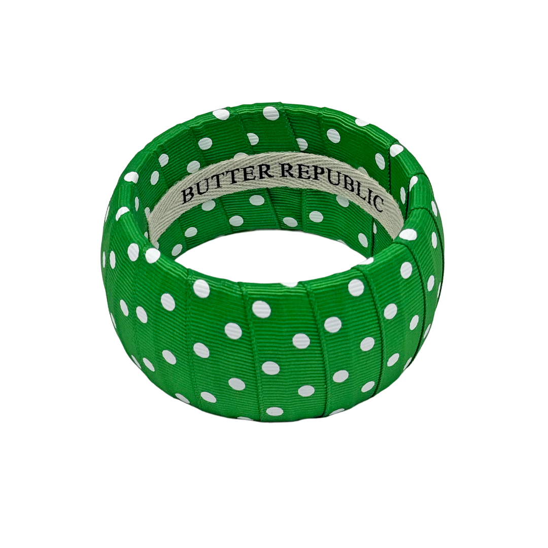 Green and white polka bracelet with Butter Republic brand label on the interior 
