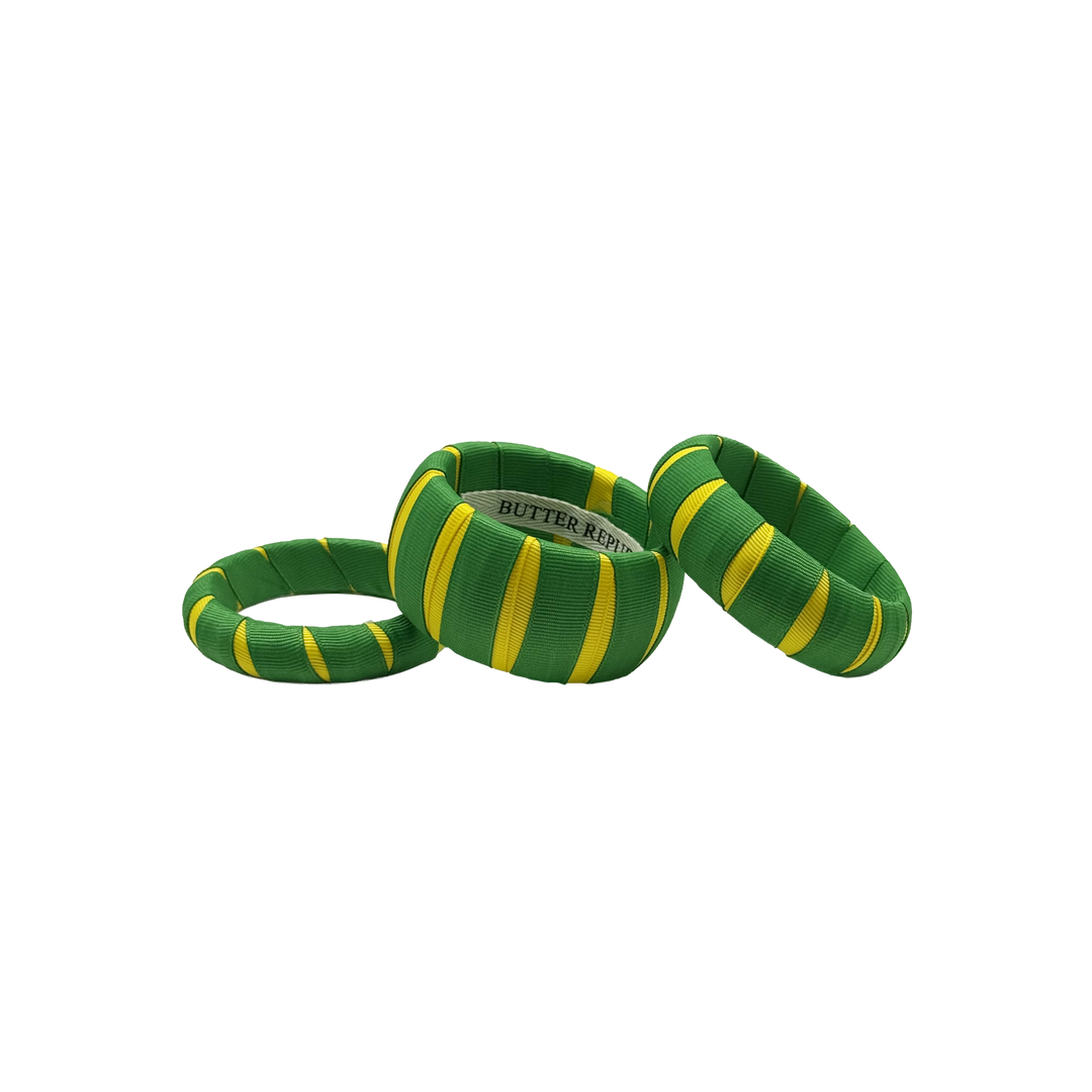three multi-width green and yellow Butter Republic bracelets with logo brand label on the interior of the bracelet
