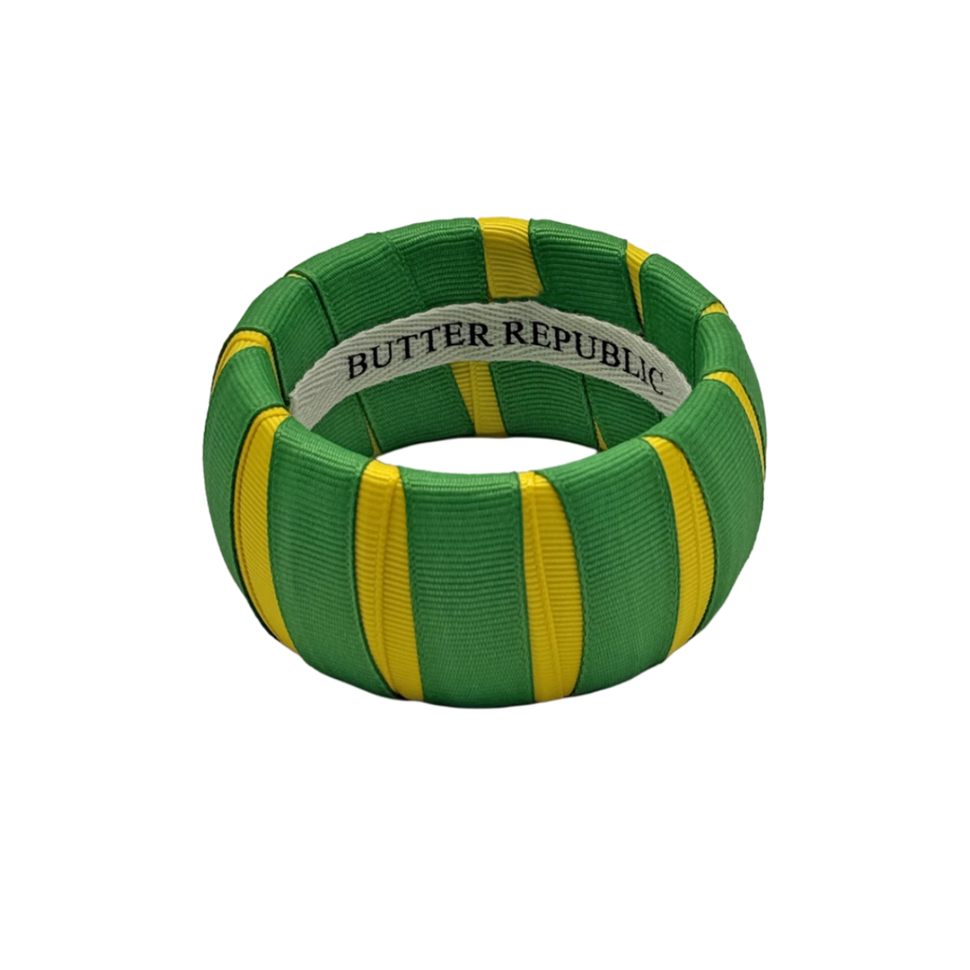 green and yellow Butter Republic bracelet with logo brand label on the interior of the bracelet