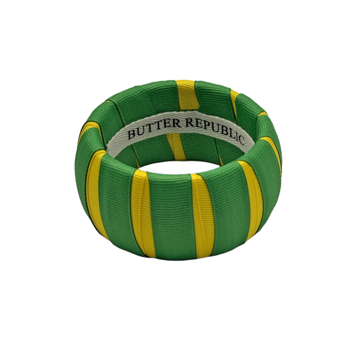 green and yellow Butter Republic bracelet with logo brand label on the interior of the bracelet