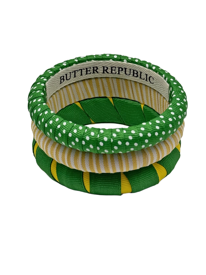 set of three green and yellow Butter Republic bracelets with brand logo label on the interior of the bracelet 